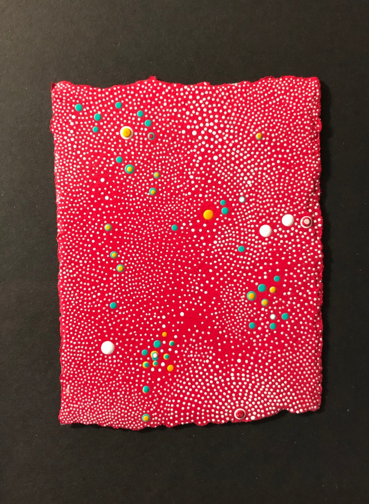 Artwork consisting of red paper with multicolored dotes of paint